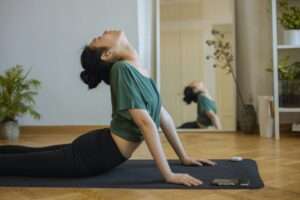 a young lady working out on a yoga mat