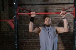 a man doing pull-ups in a gym