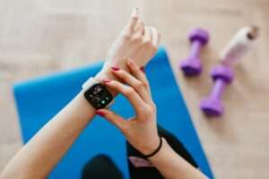 a person wearing a smart watch, top ten latest health and fitness gadgets