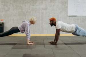 a man and a woman doing push-up exercise