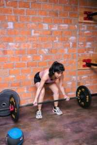 a woman doing deadlifts at a gym for fitness