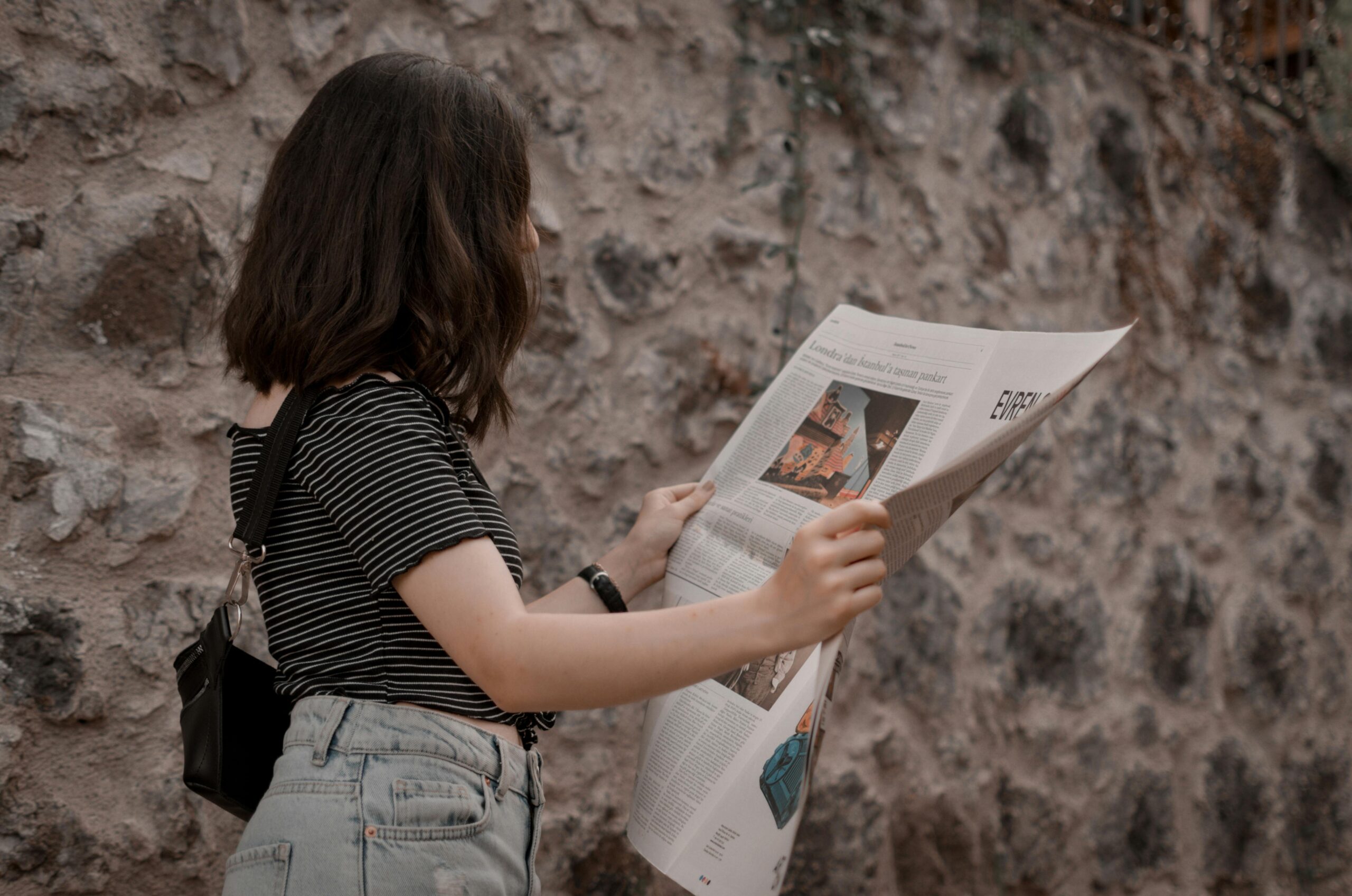 a woman reading a newspaper