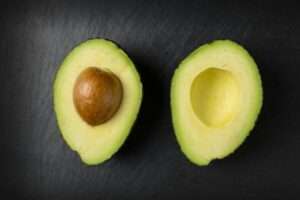 an avocado sliced into two for a recipe to boost your health and fitness