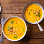 two bowls of lentil soup with spinach and turmeric