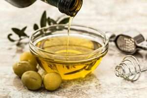 olive oil in a bowl to flavor the grilled salmon with roasted vegetables